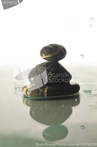 Image of isolated wet zen stones with splashing  water drops