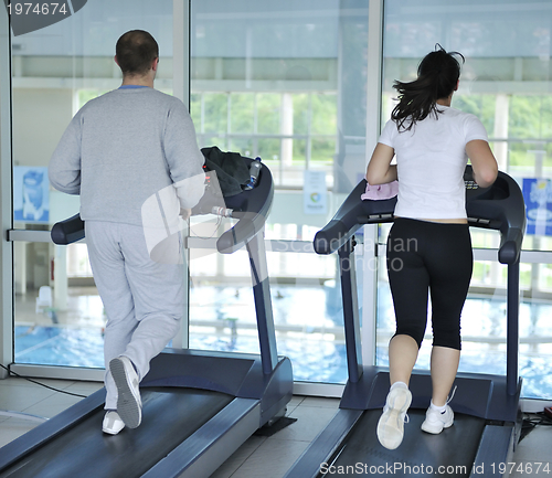 Image of people running on threadmill at fitness club