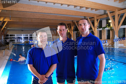 Image of .swimming school instructors at pool