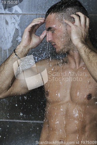 Image of good looking man under man shower