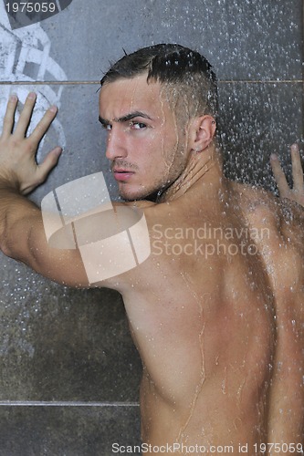 Image of good looking man under man shower