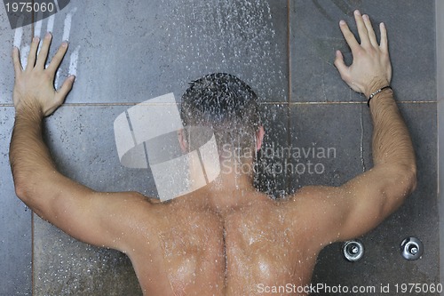 Image of good looking man under man shower