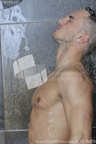 Image of good looking man under man shower