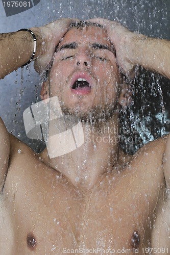 Image of good looking man under man shower