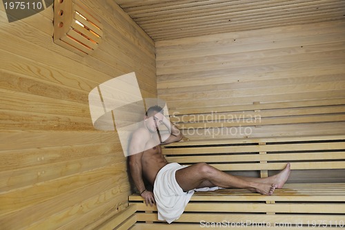 Image of attractive young man in sauna