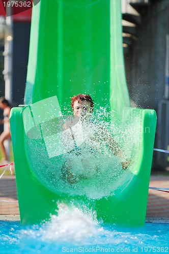 Image of girl have fun  on water slide at outdoor swimming pool