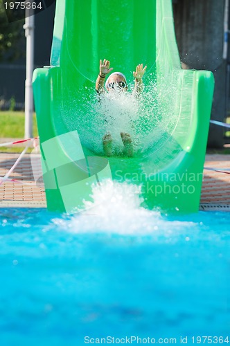 Image of girl have fun  on water slide at outdoor swimming pool