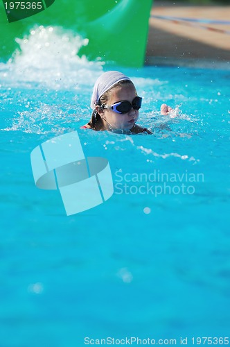 Image of girl have fun  on water slide at outdoor swimming pool