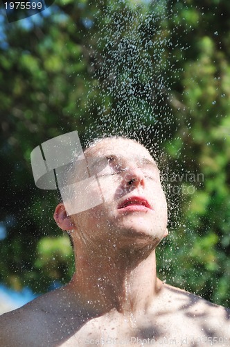 Image of man wash head under shower with falling water