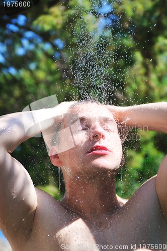 Image of man wash head under shower with falling water