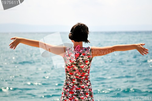 Image of Young pretty woman enjoying the sun