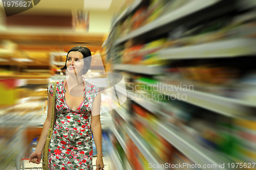 Image of Young woman shopping in market
