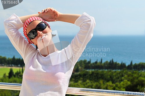 Image of Young pretty woman enjoying the sun
