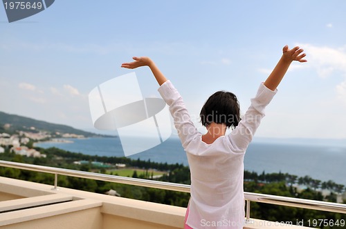 Image of Young pretty woman enjoying the sun