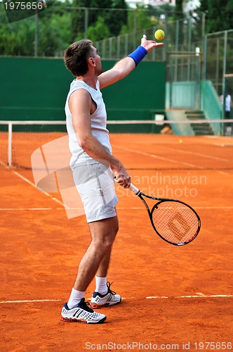 Image of One man play tennis outdoors