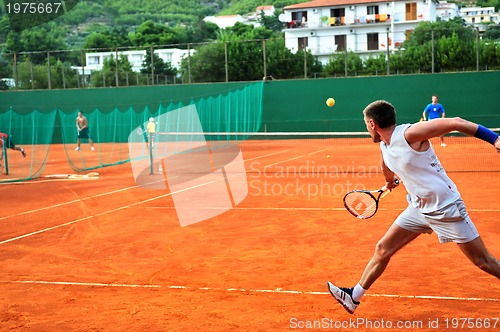 Image of Man plays tennis outdoors