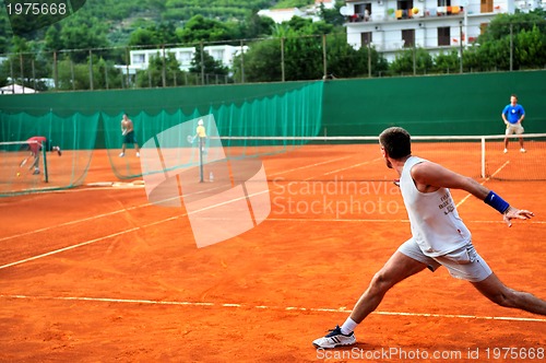 Image of Man plays tennis outdoors