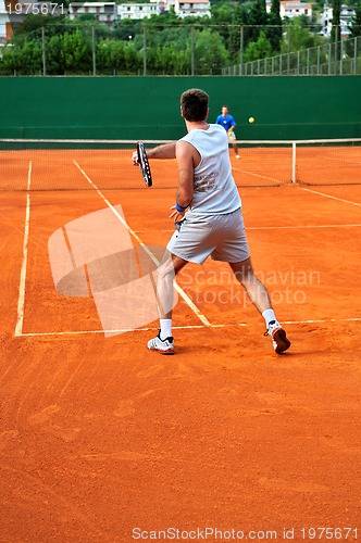 Image of Man plays tennis outdoors