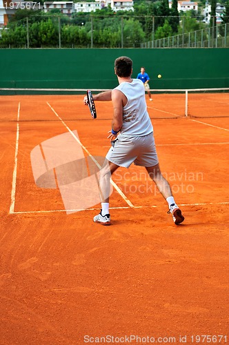 Image of Man plays tennis outdoors