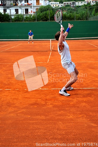 Image of Man plays tennis outdoors