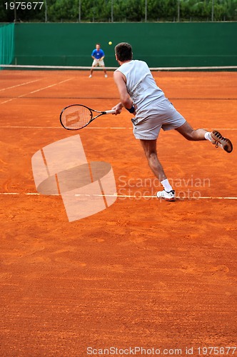 Image of One man play tennis outdoors