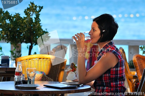 Image of Young lady having dinner