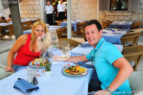 Image of Young couple having dinne