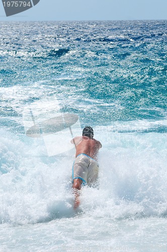 Image of man jumping in sea