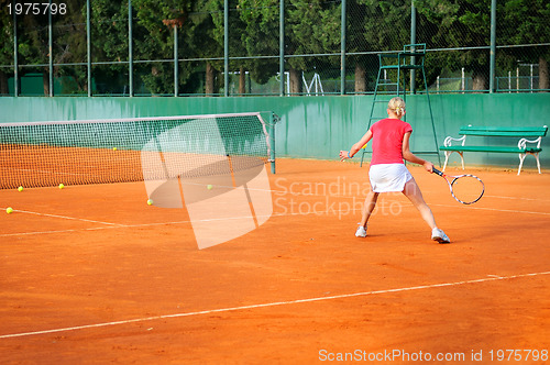 Image of Girl playing tennis outdoor