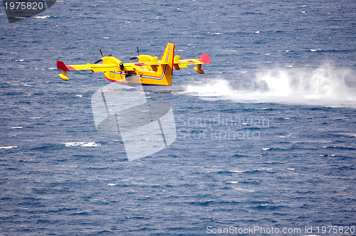 Image of Airplane on sea taking water