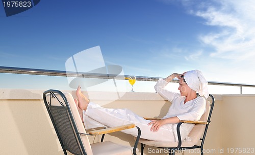 Image of young girl siting in chair, juice, drink, fresh, orange, healthy