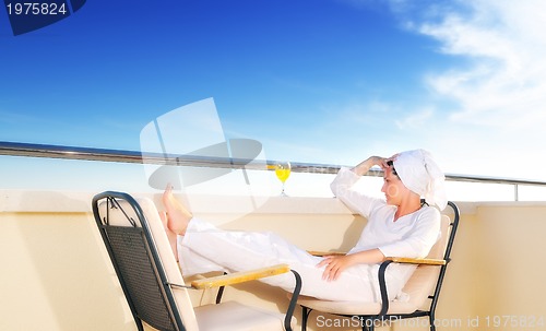 Image of young girl siting in chair, juice, drink, fresh, orange, healthy