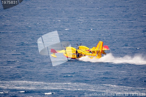 Image of Airplane on sea taking water