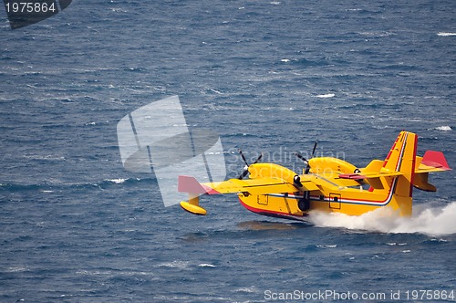 Image of Airplane on sea taking water