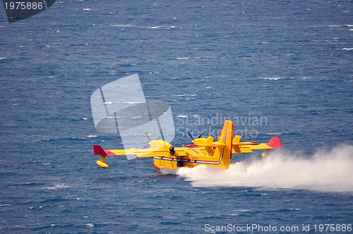 Image of Airplane on sea taking water