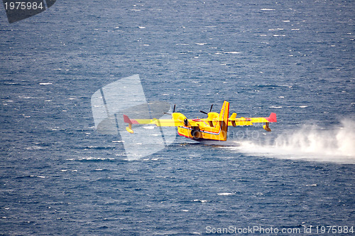 Image of Airplane on sea taking water