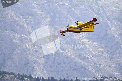 Image of Airplane droping water on fire 