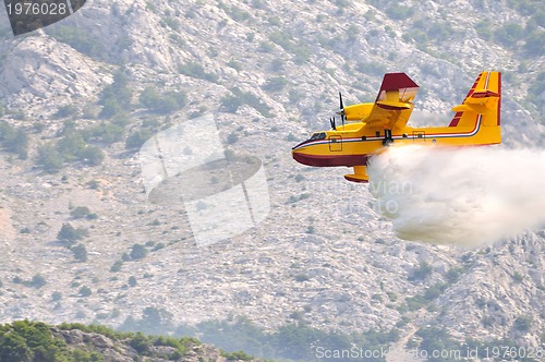 Image of Airplane droping water on fire 