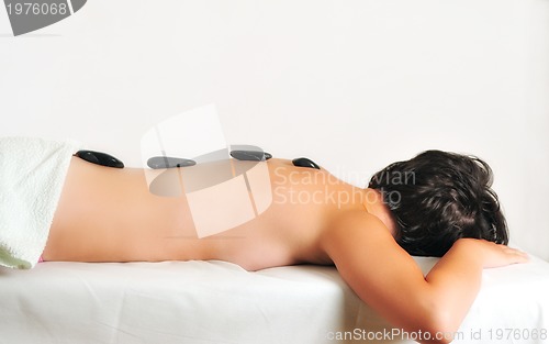 Image of beautiful woman have hotstone massage at spa and wellness center