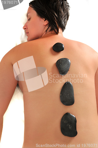 Image of beautiful woman have hotstone massage at spa and wellness center