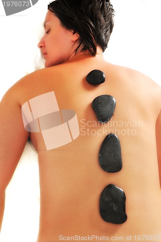 Image of beautiful woman have hotstone massage at spa and wellness center