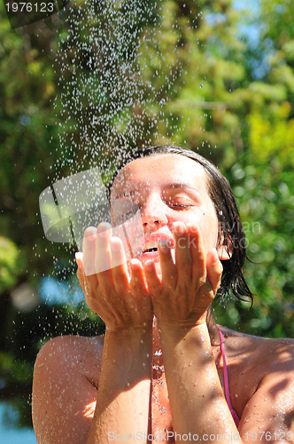Image of young pretty woman relaxing under shower