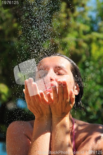 Image of young pretty woman relaxing under shower