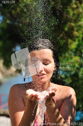 Image of young pretty woman relaxing under shower
