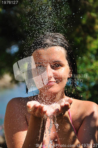 Image of young pretty woman relaxing under shower