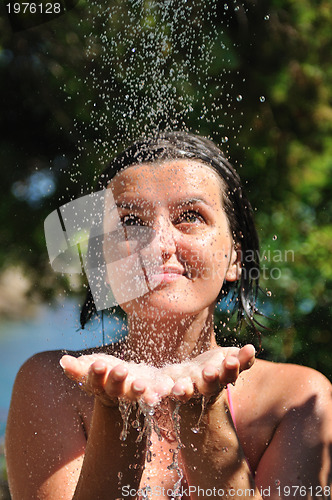 Image of young pretty woman relaxing under shower