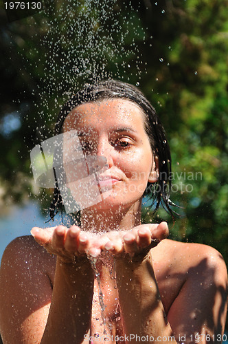 Image of young pretty woman relaxing under shower