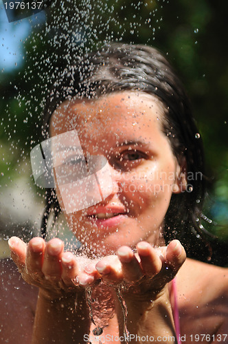 Image of young pretty woman relaxing under shower