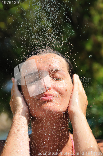 Image of young pretty woman relaxing under shower