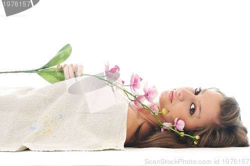 Image of beautiful young  woman face with flower and towel